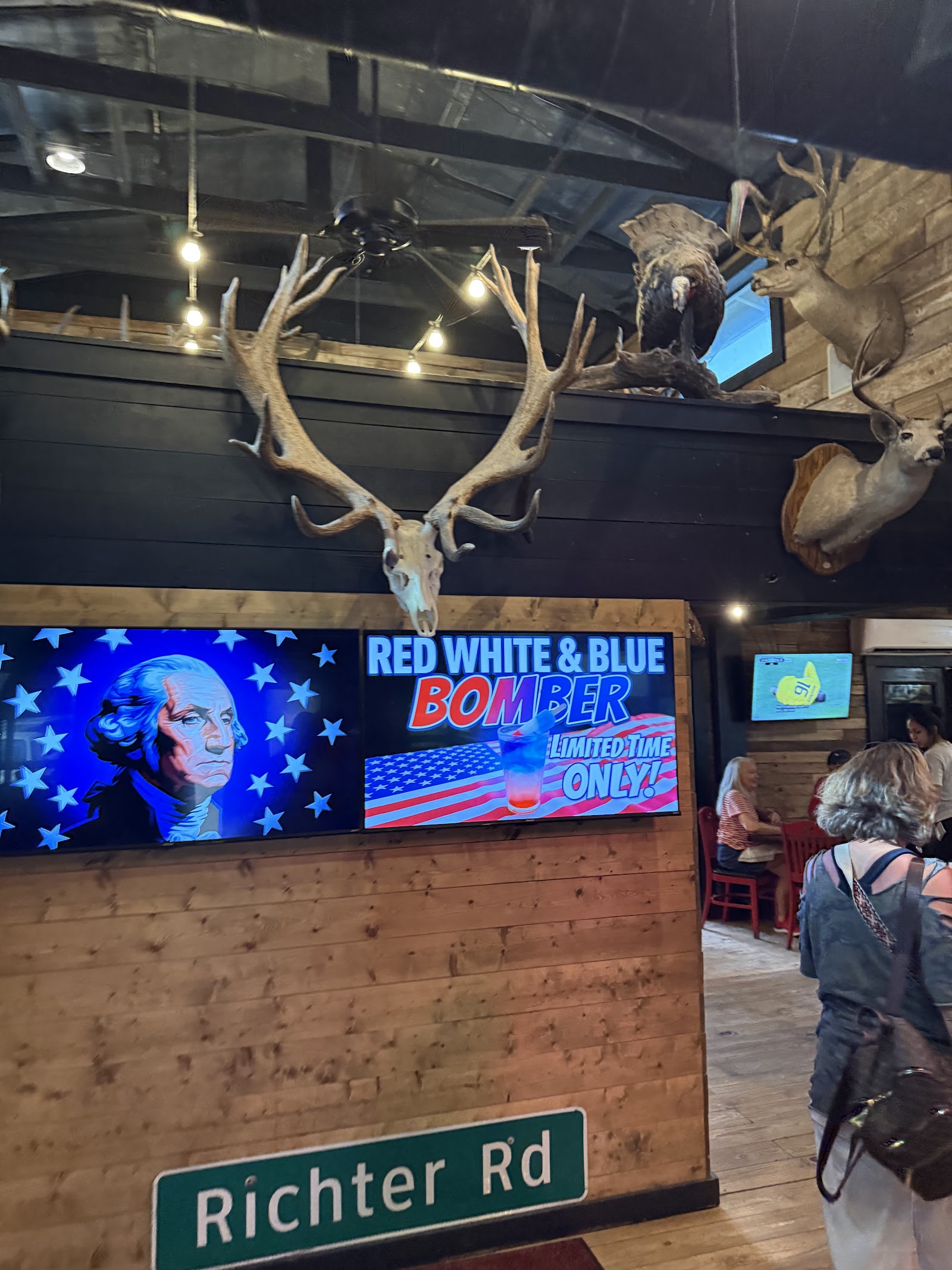 Bar area inside Richter's Antler Cafe with antler chandelier and TVs