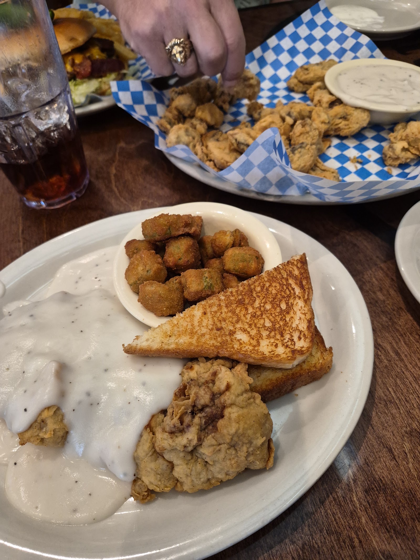 Basket of fried okra and pickles with ranch dressing