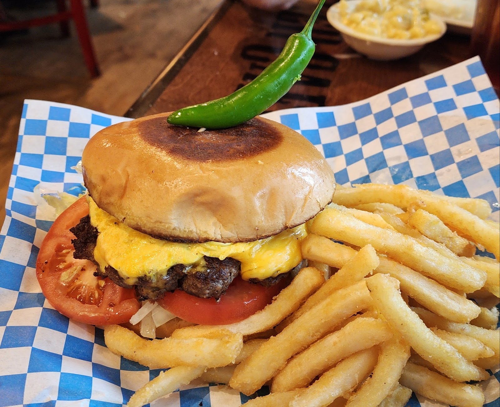 Jalapeño cheeseburger with a side of fries